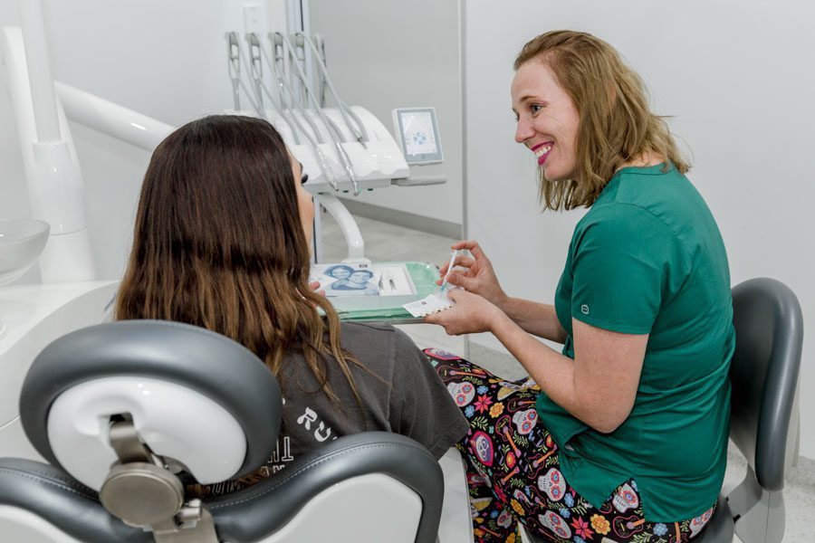 Female dentist looking at patient